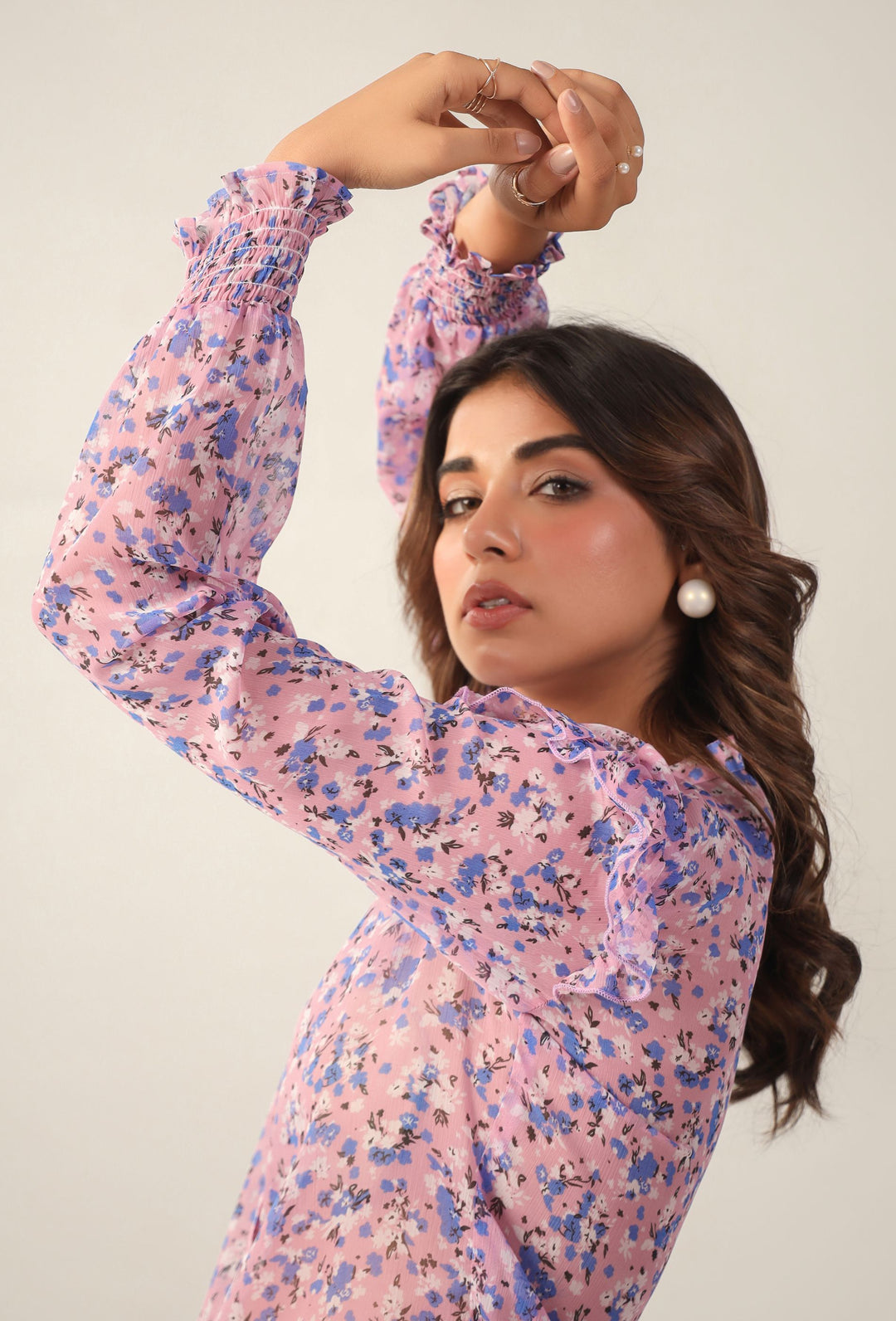Pink floral long sleeve top with ruffled cuffs and neckline, styled for Western wear
