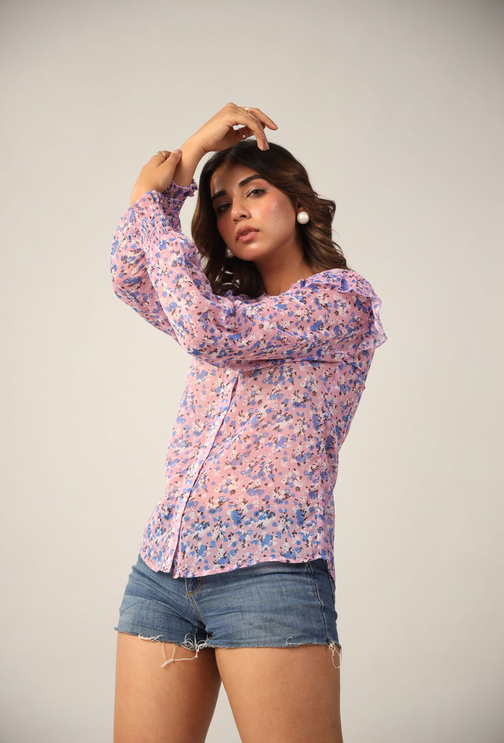 Pink floral long sleeve blouse with ruffled neckline and denim shorts for women's Western wear