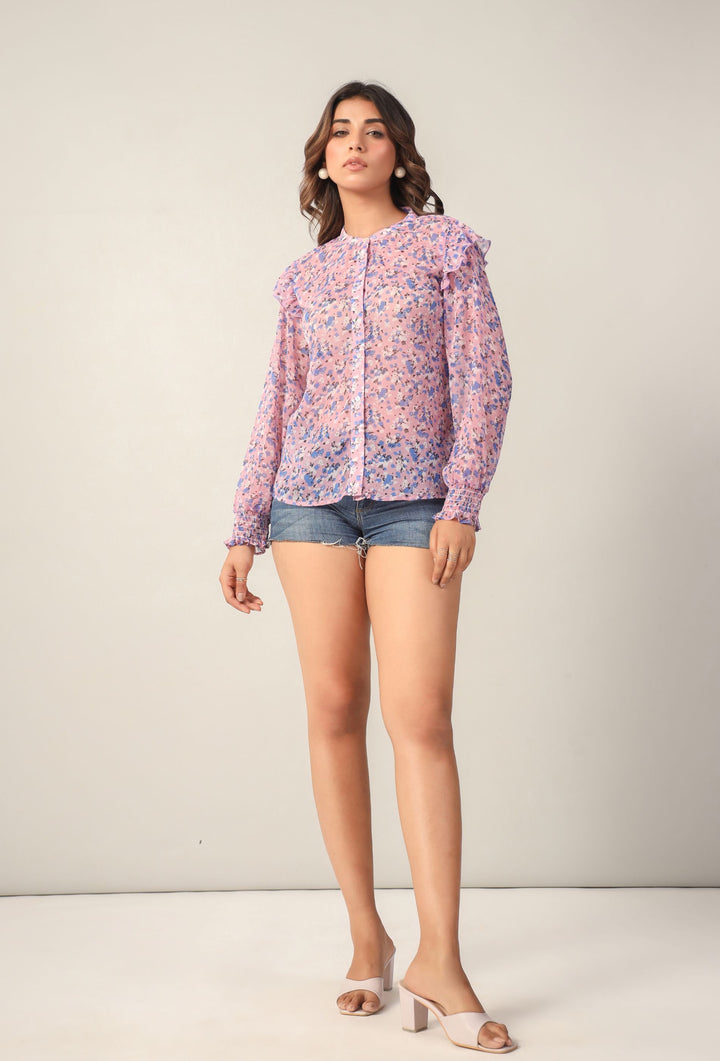 Pink floral blouse with ruffled sleeves and denim shorts for women's Western wear