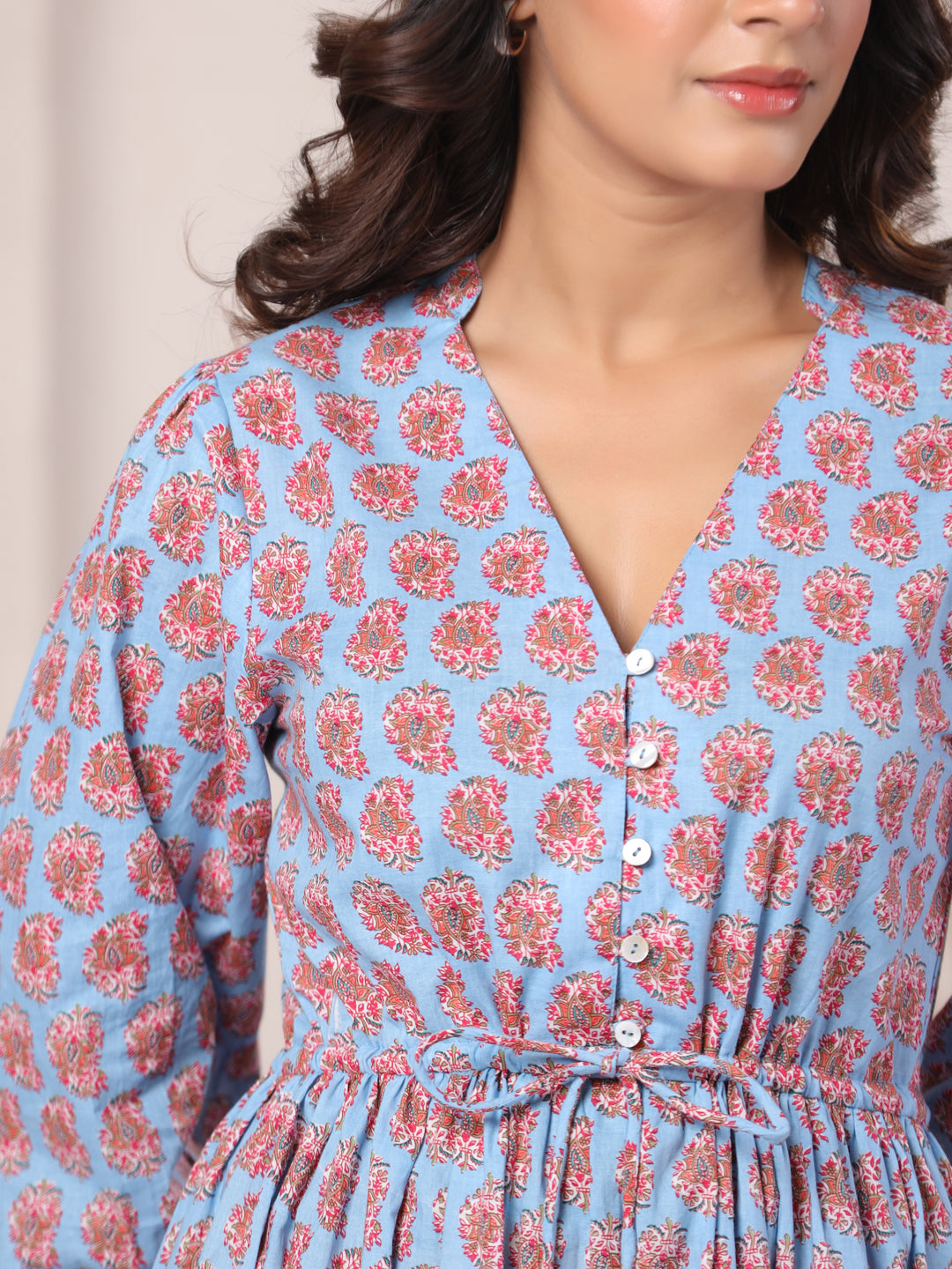 Hemline detail of powder blue paisley print maxi dress with flowing finish