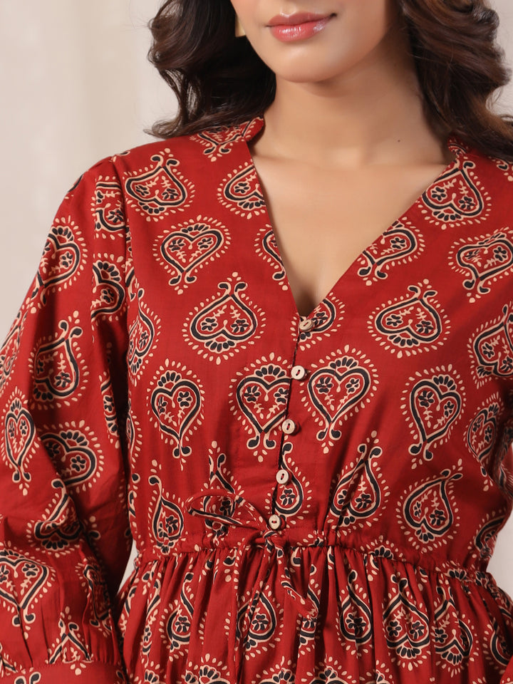 Close-up of Ajrakh buta print on red cotton fabric handcrafted design | Button view