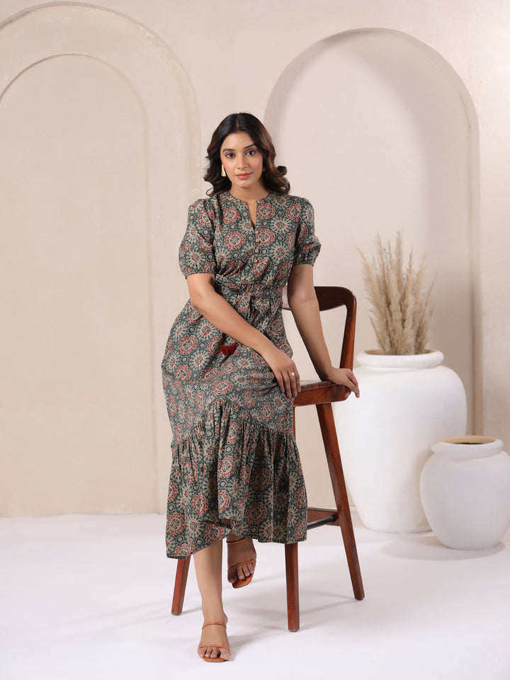 Woman wearing green Ajrakh print cotton bohemian dress for women | Sitting view
