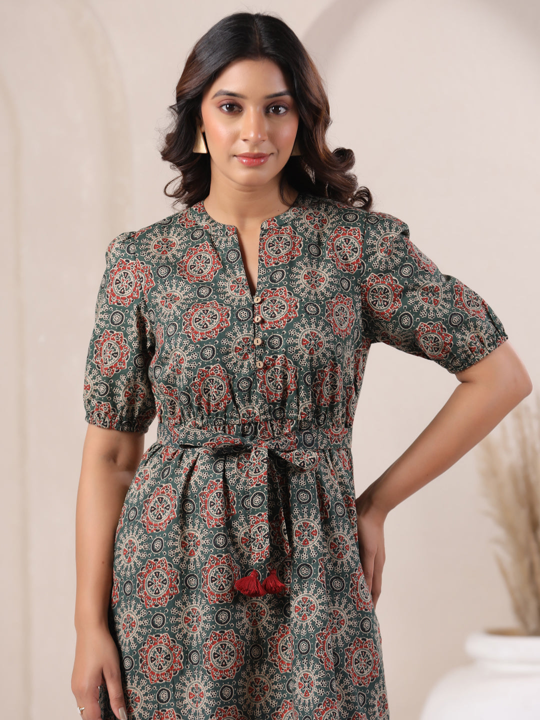 Close-up of Ajrakh print cotton fabric on green bohemian dress for women