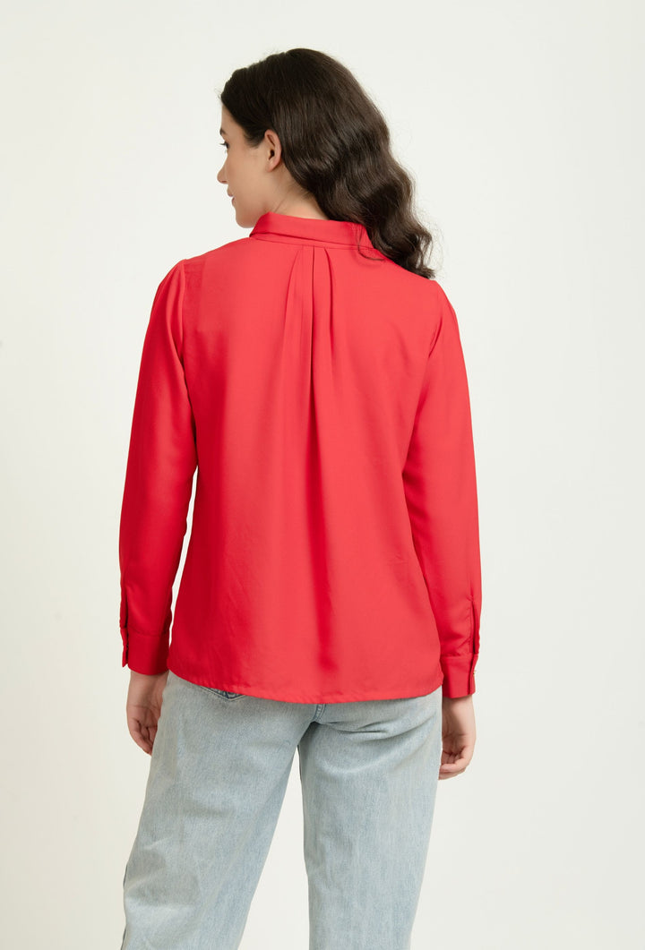 Red long sleeve women's blouse with back pleat, paired with light jeans for Western wear style