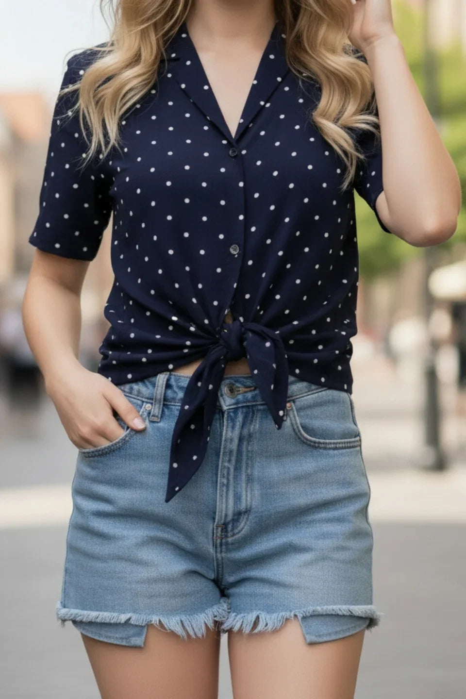 Close-up on the notched collar and polka dot pattern of the June 9 Clothing tie-up top.