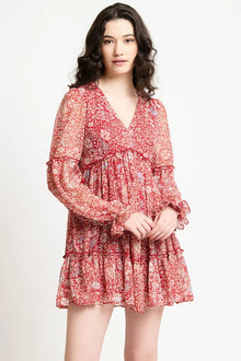 Woman wearing a red floral print long-sleeve mini dress with ruffle details