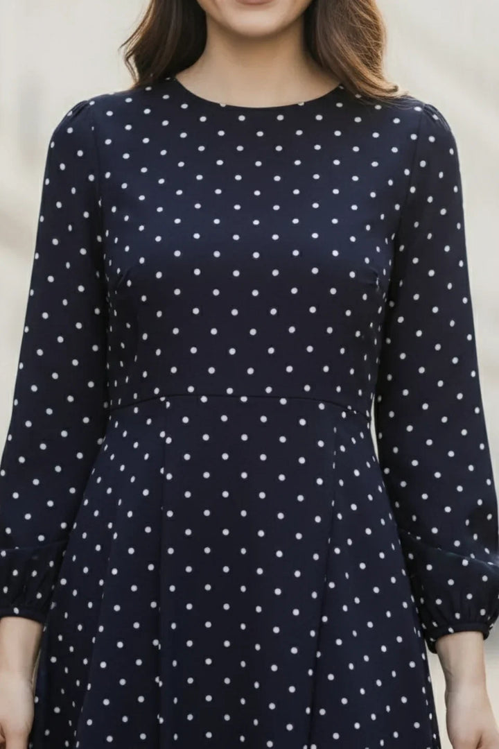 Close-up of the round neckline and polka dot pattern on the Navy Blue mini dress (June 9 Clothing).
