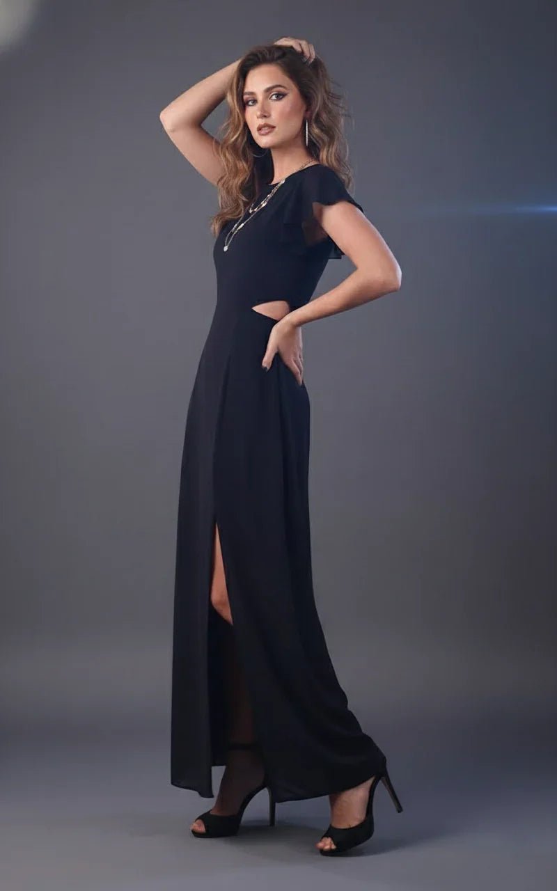 Woman wearing black maxi dress with side cutouts, flutter sleeves, and front slit
