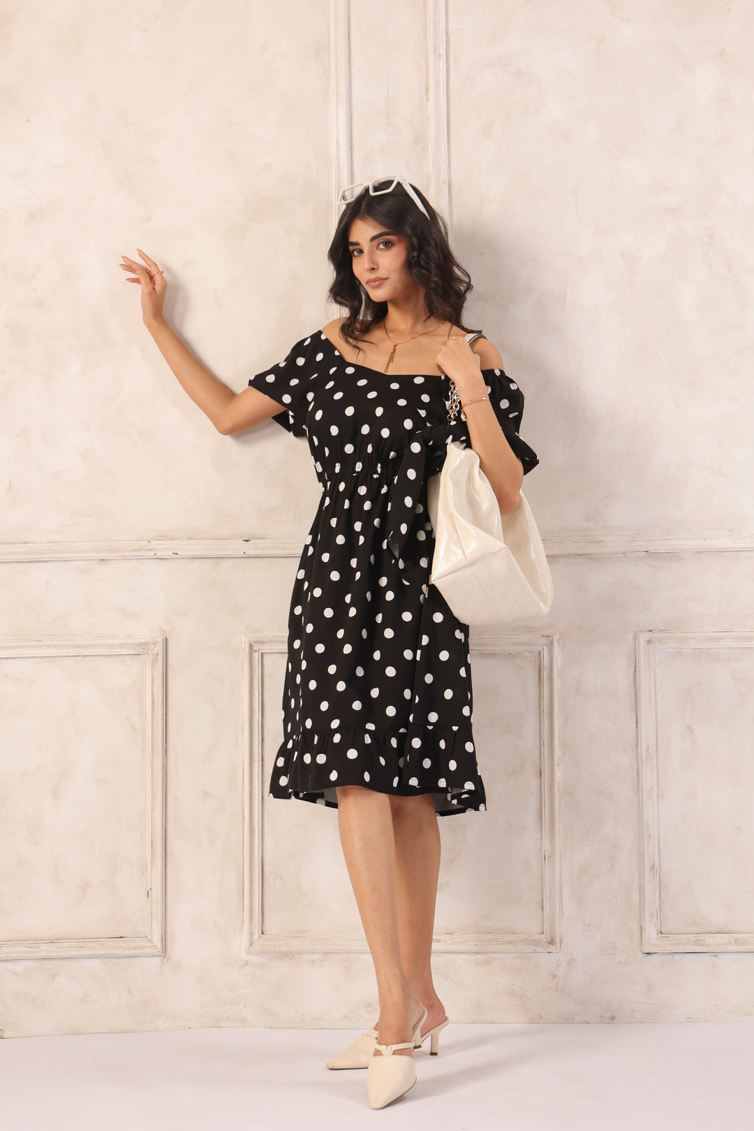 Black polka dot mini dress women playful pose lightweight short summer dress
