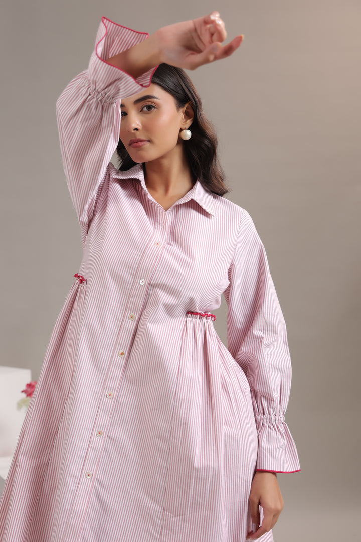 Detailed view of red and white striped pattern and button-down collar neck.