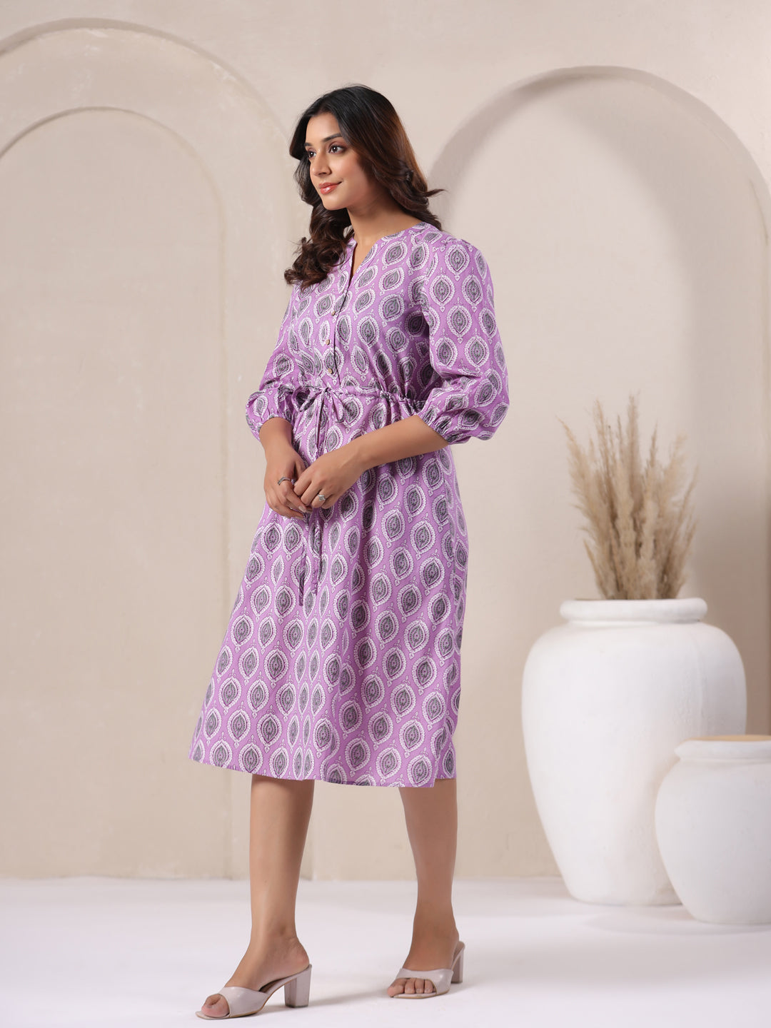 Side angle of lavender buti print cotton midi dress showing flowy hemline - right side