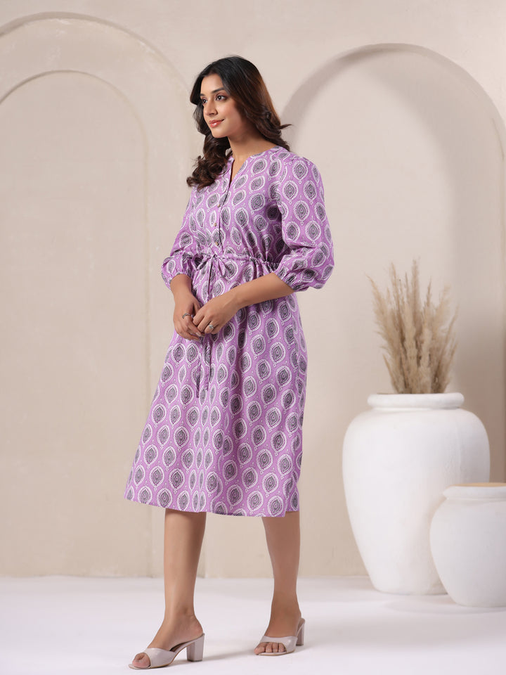 Side angle of lavender buti print cotton midi dress showing flowy hemline - right side