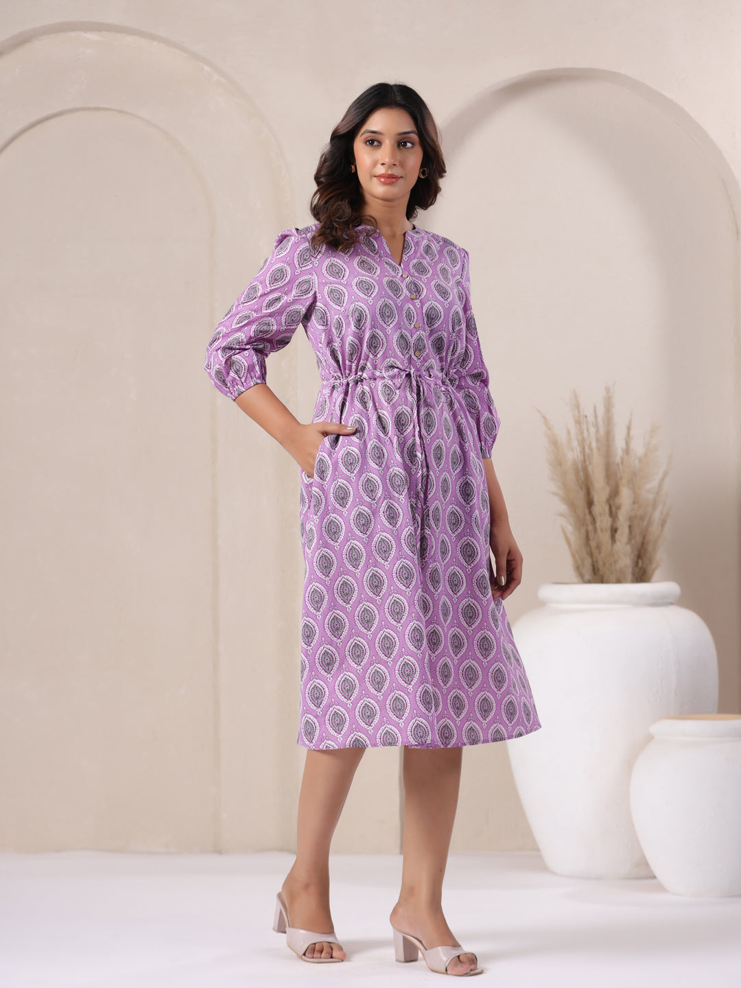 Side angle of lavender buti print cotton midi dress showing flowy hemline - Left side