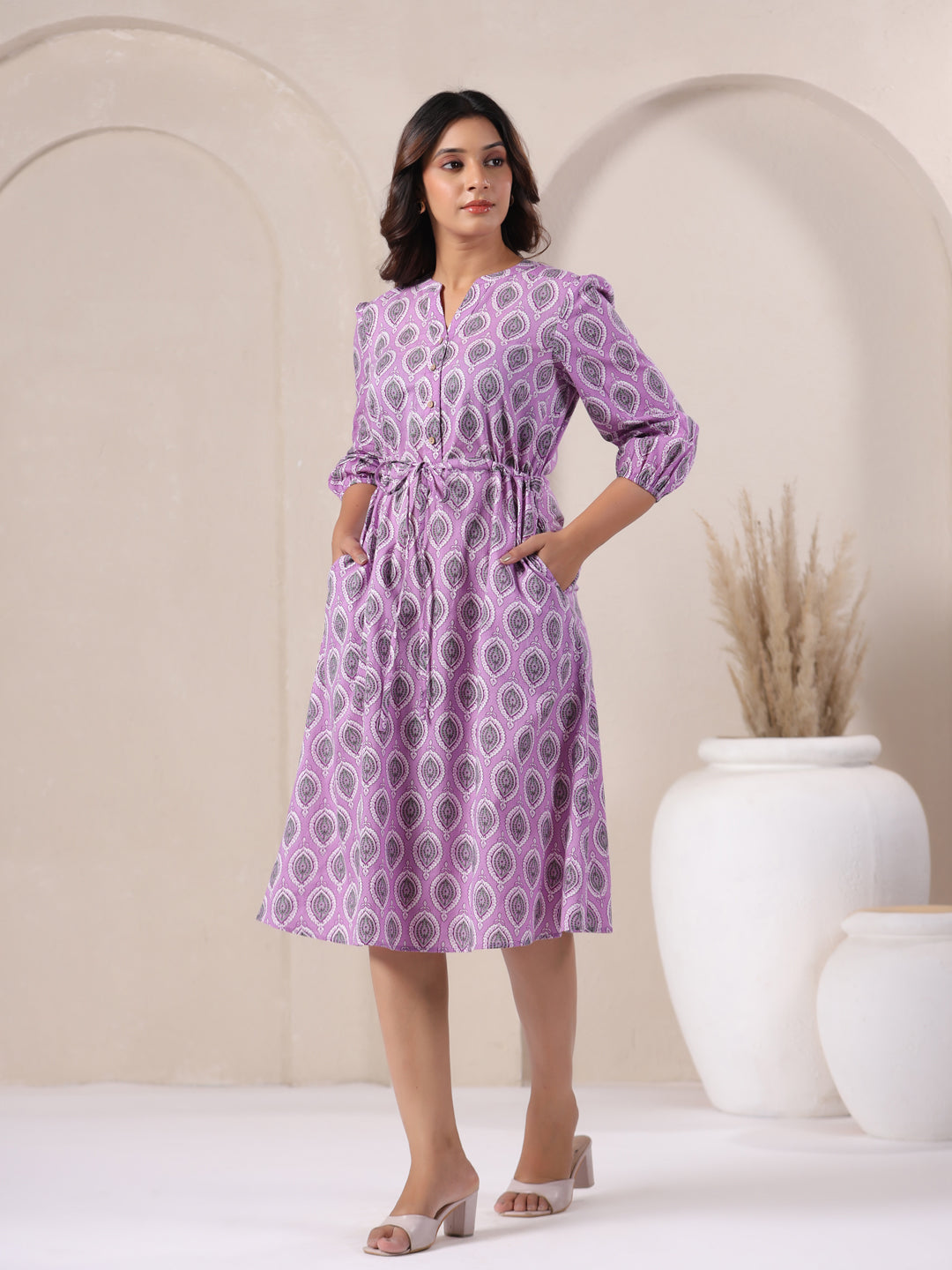 Side angle of lavender buti print cotton midi dress showing flowy hemline