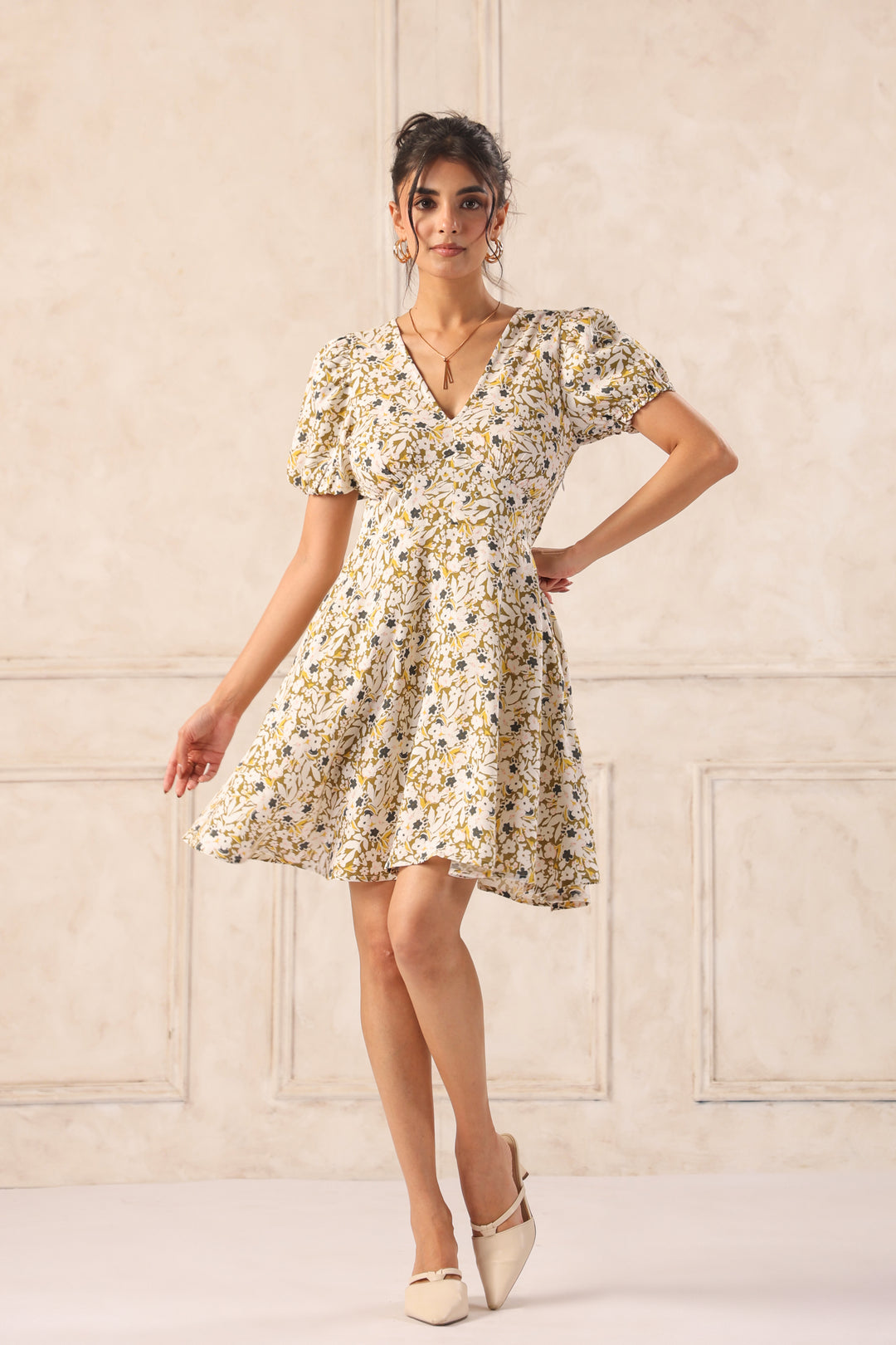 Floral print dress with puff sleeves and V-neck, styled with beige heels for chic Western wear.