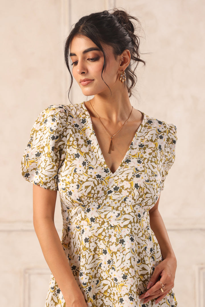 Woman in floral print dress with puff sleeves, gold jewelry, and elegant updo hairstyle.