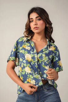 Woman in blue floral button-up shirt and jeans, Western wear, studio background