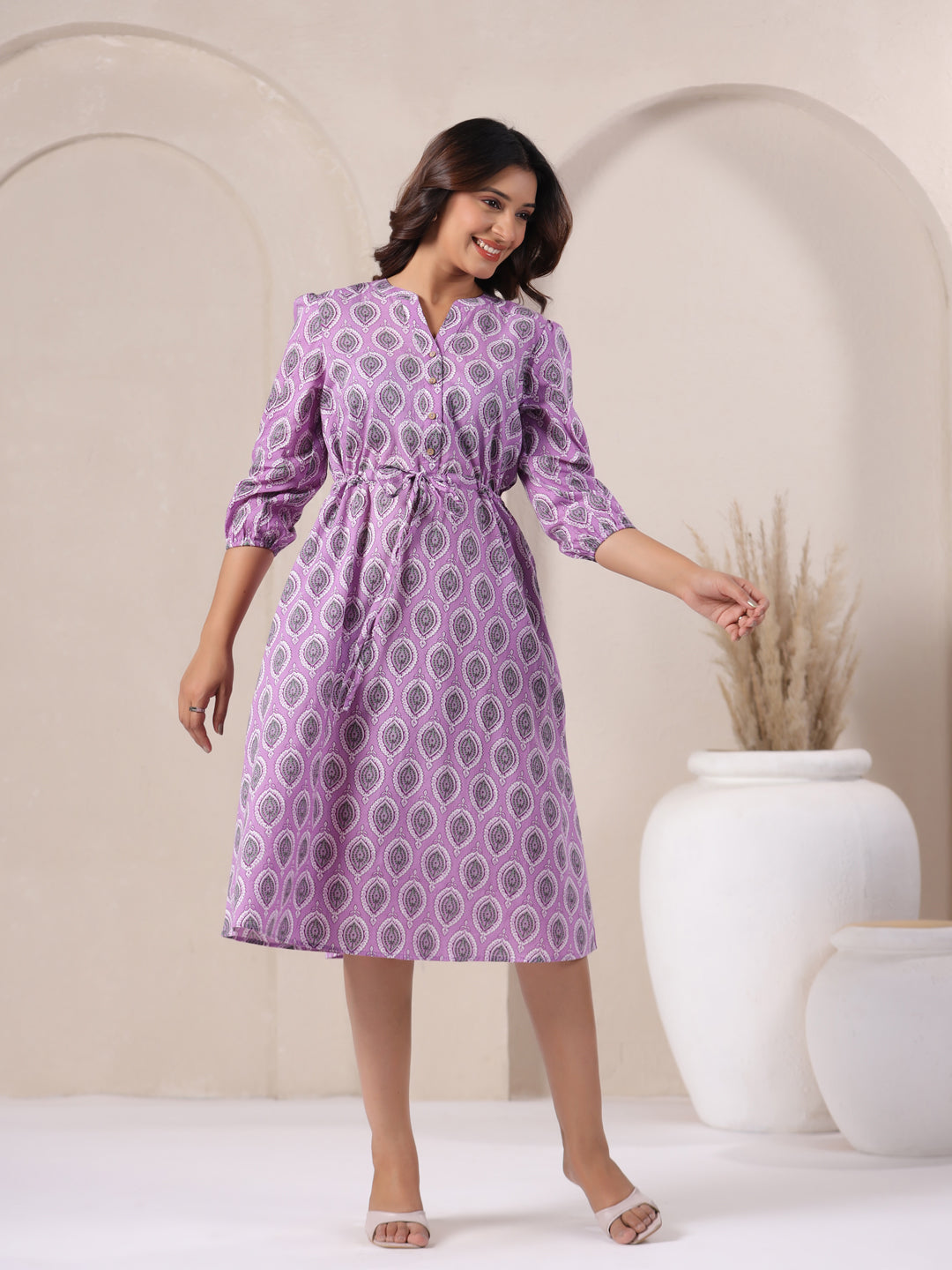 Woman wearing lavender cotton midi dress styled for casual daytime wear in India