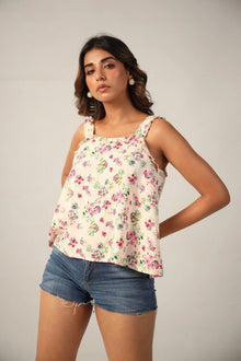 Woman in floral sleeveless top and denim shorts, Western wear fashion