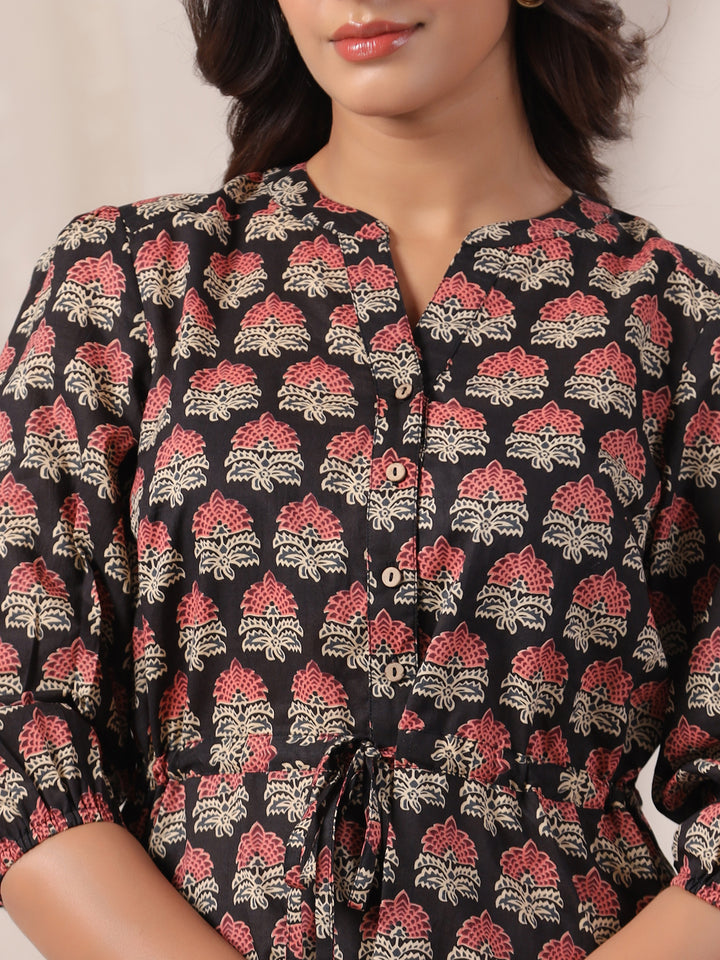 Close-up of traditional Ajrakh buta hand block print on black woven cotton fabric.