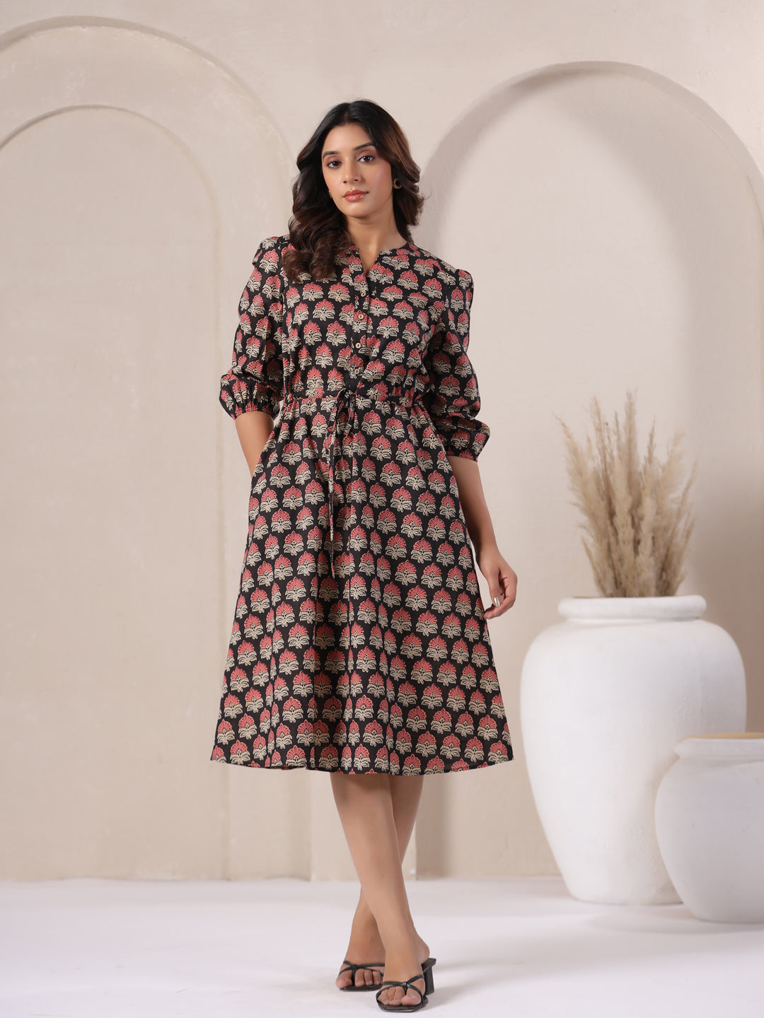 Black Ajrakh midi dress styled casually with flats for a summer day out.