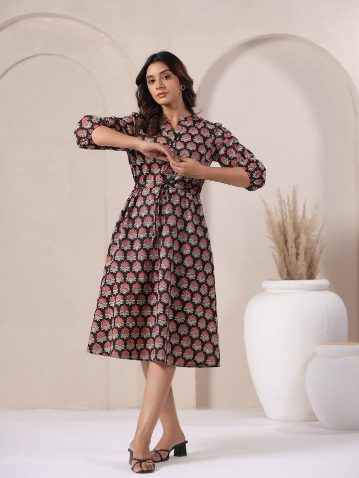 Black Ajrakh midi dress styled casually with flats for a summer day out.