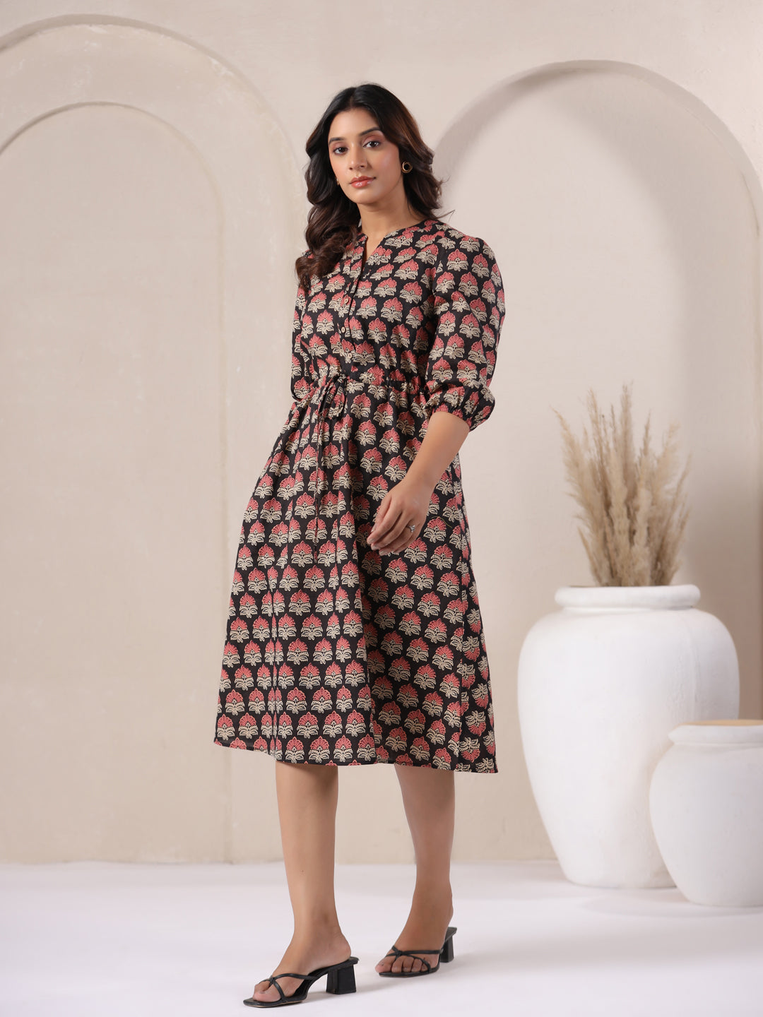 Black Ajrakh midi dress styled with jewelry for an evening or party look.