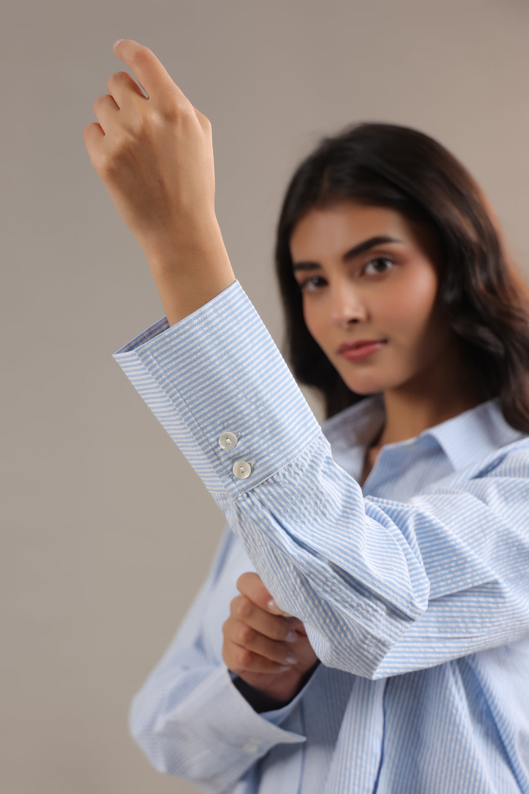 Long sleeve detail of blue striped shirt womens with clean cuff finish