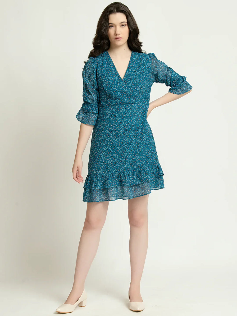 Model wearing a stylish chiffon floral mini dress online India with three-quarter sleeves and a ruffled hemline