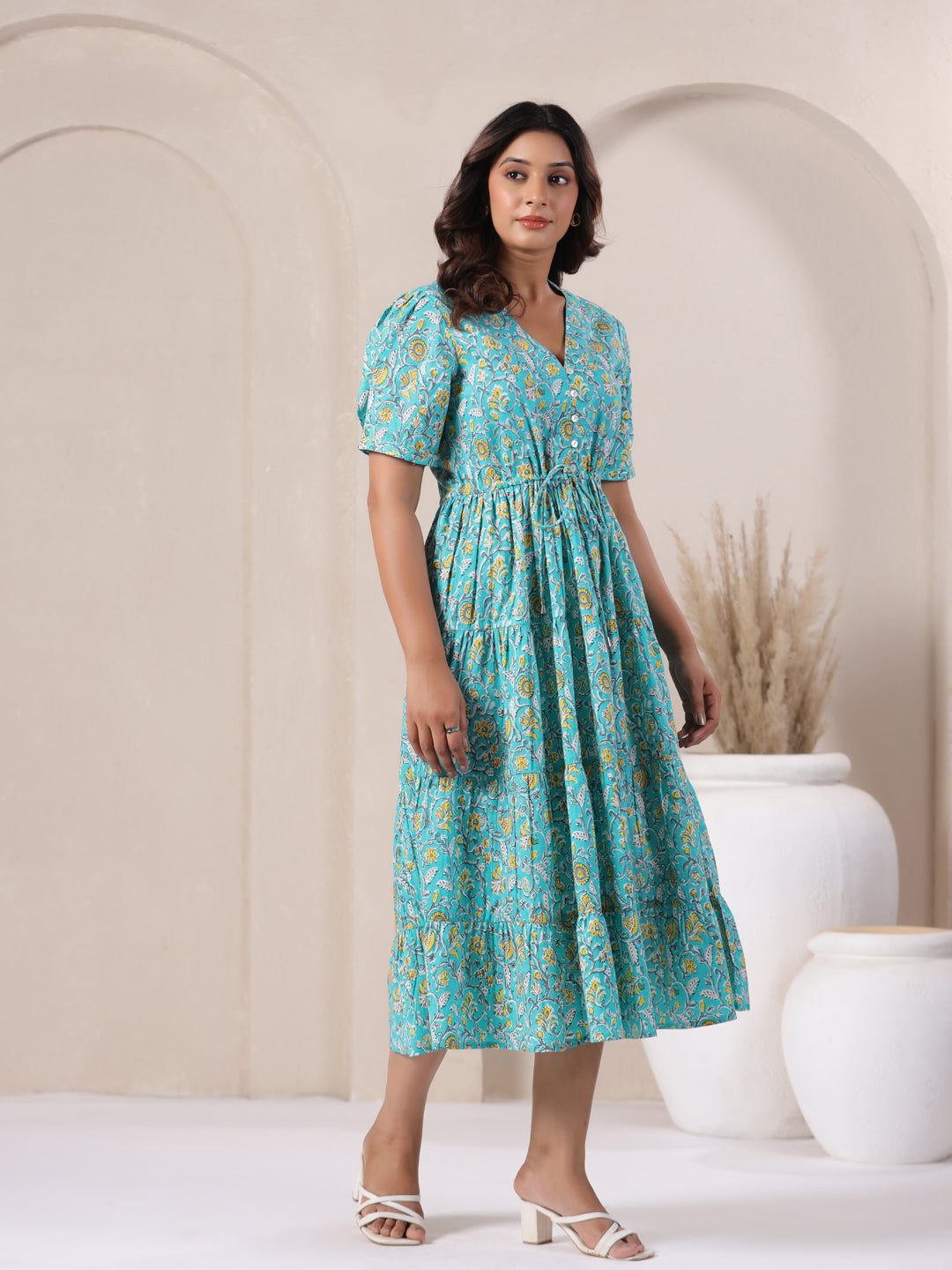 Fit and flare sky blue maxi dress with 3/4 sleeves and floral motifs.