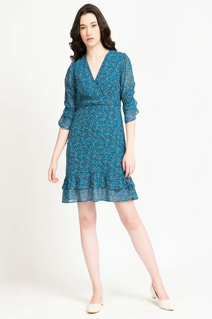 Front view of a teal mini dress for women featuring a V-neck and chiffon floral print, available online in India